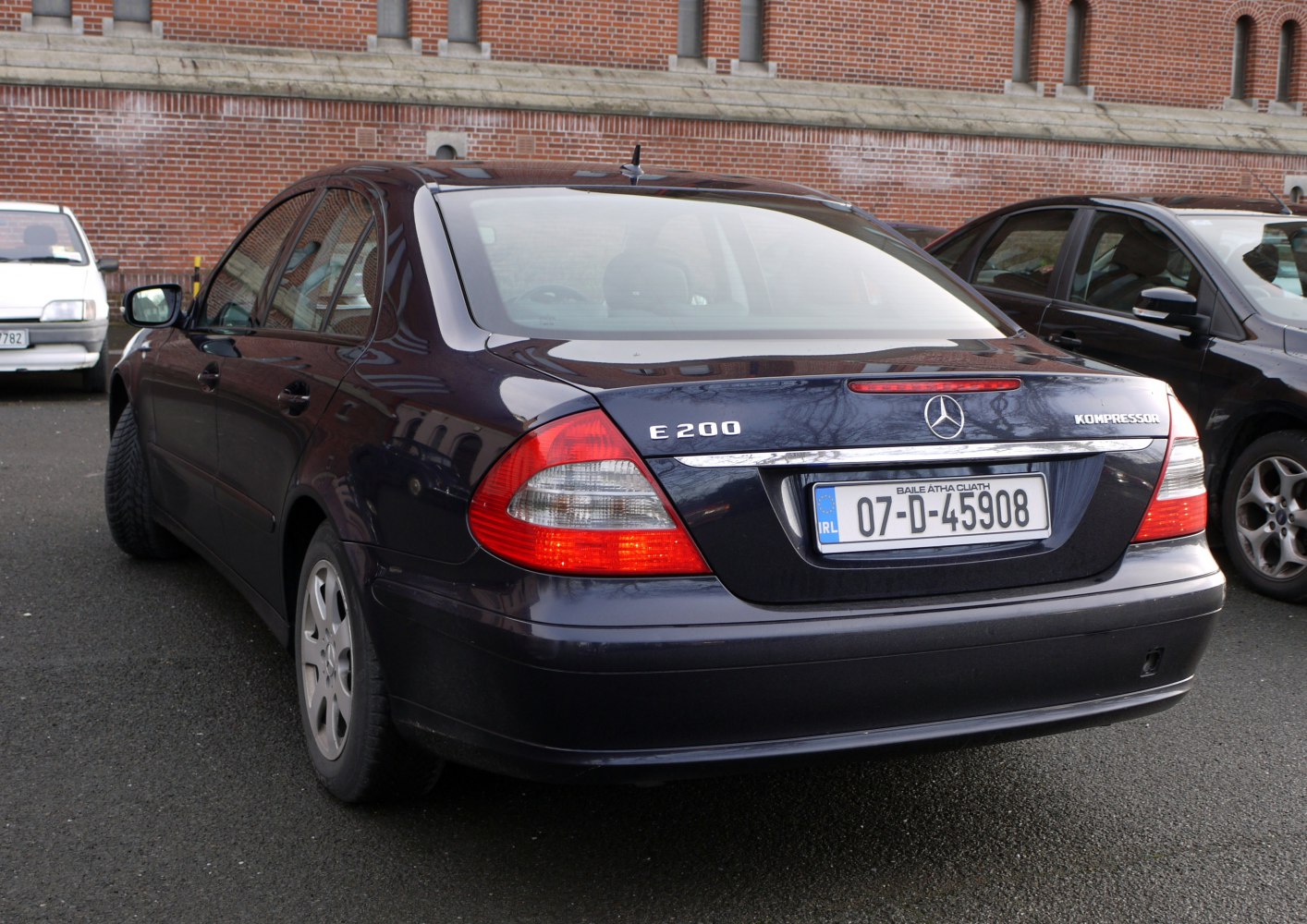 Rear view of a luxury sedan with E200 Kompressor badge and distinct tail lights