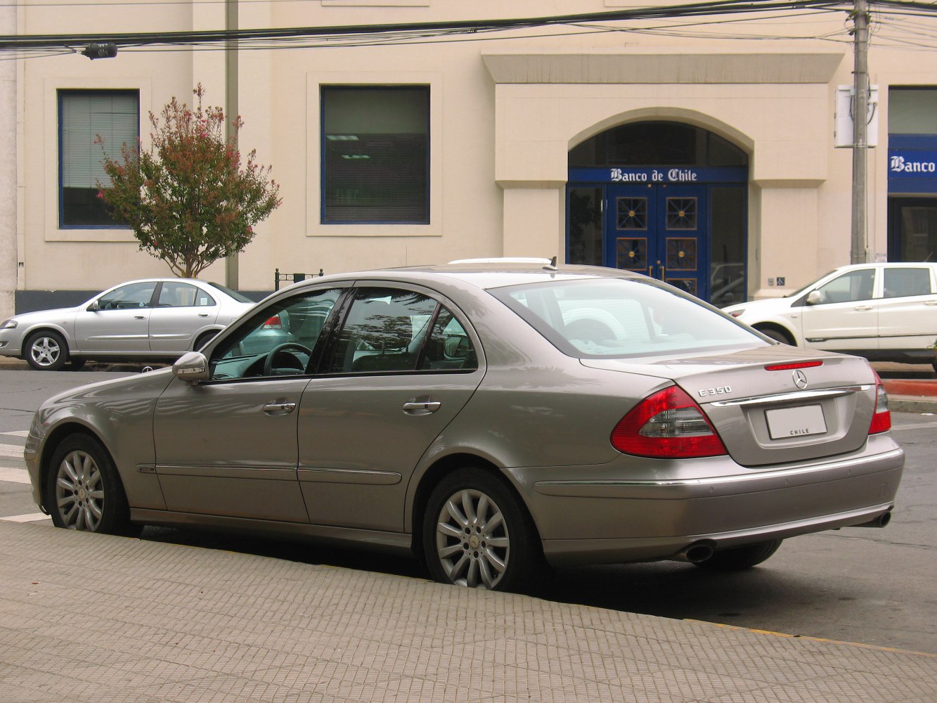Rear and side view of a mid-2000s luxury sedan with alloy wheels
