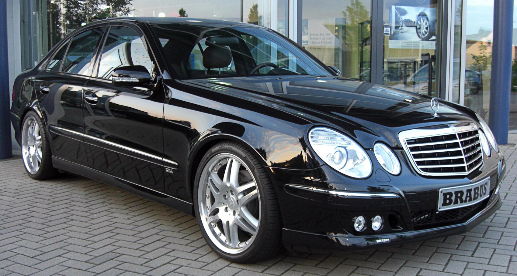 Twin rounded headlights, chrome grille, sporty alloy wheels on luxury sedan