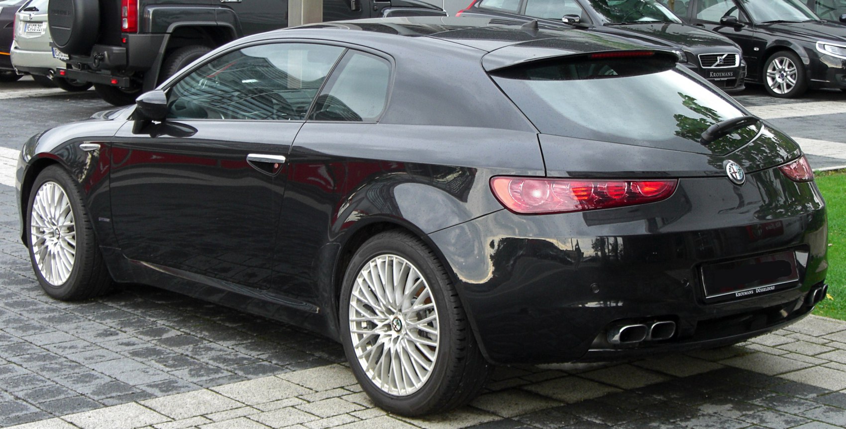 Rear view showing sleek taillights and dual exhaust system on hatchback.