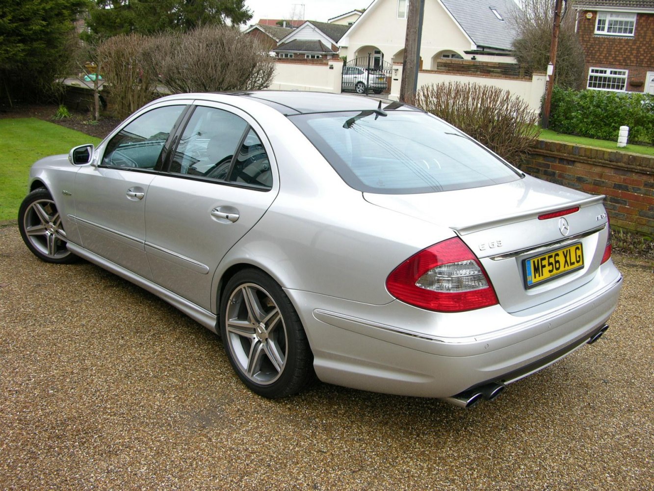 Silver sedan rear side view with alloy wheels and quad exhausts