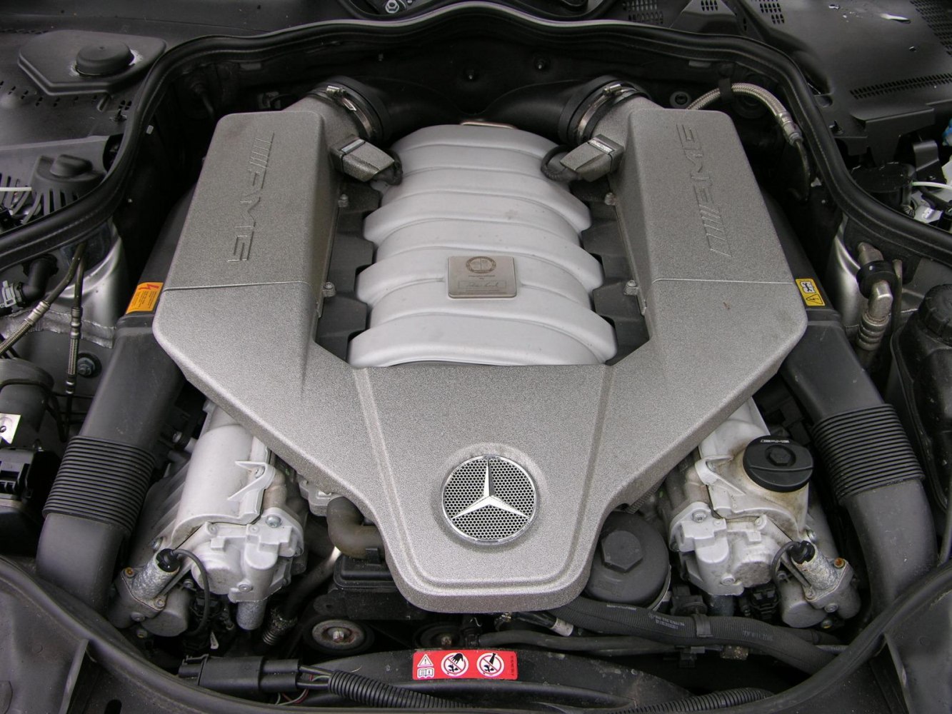 AMG engine bay with iconic Mercedes emblem and engine cover