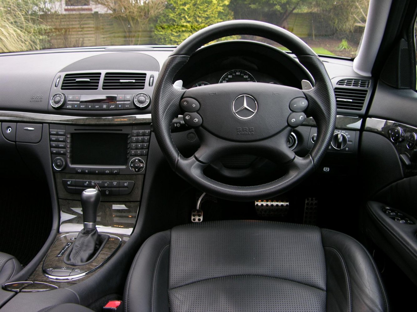 Steering wheel and dashboard with control buttons and automatic gear shifter