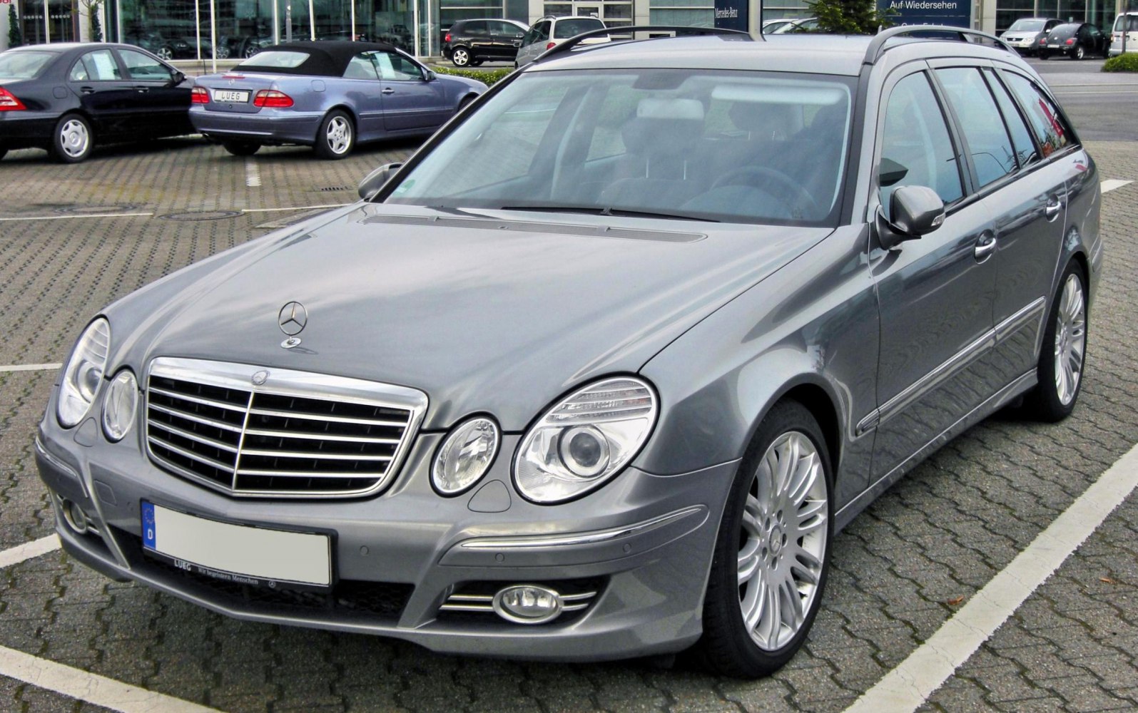 Front grille and dual oval headlights of a silver silver wagon