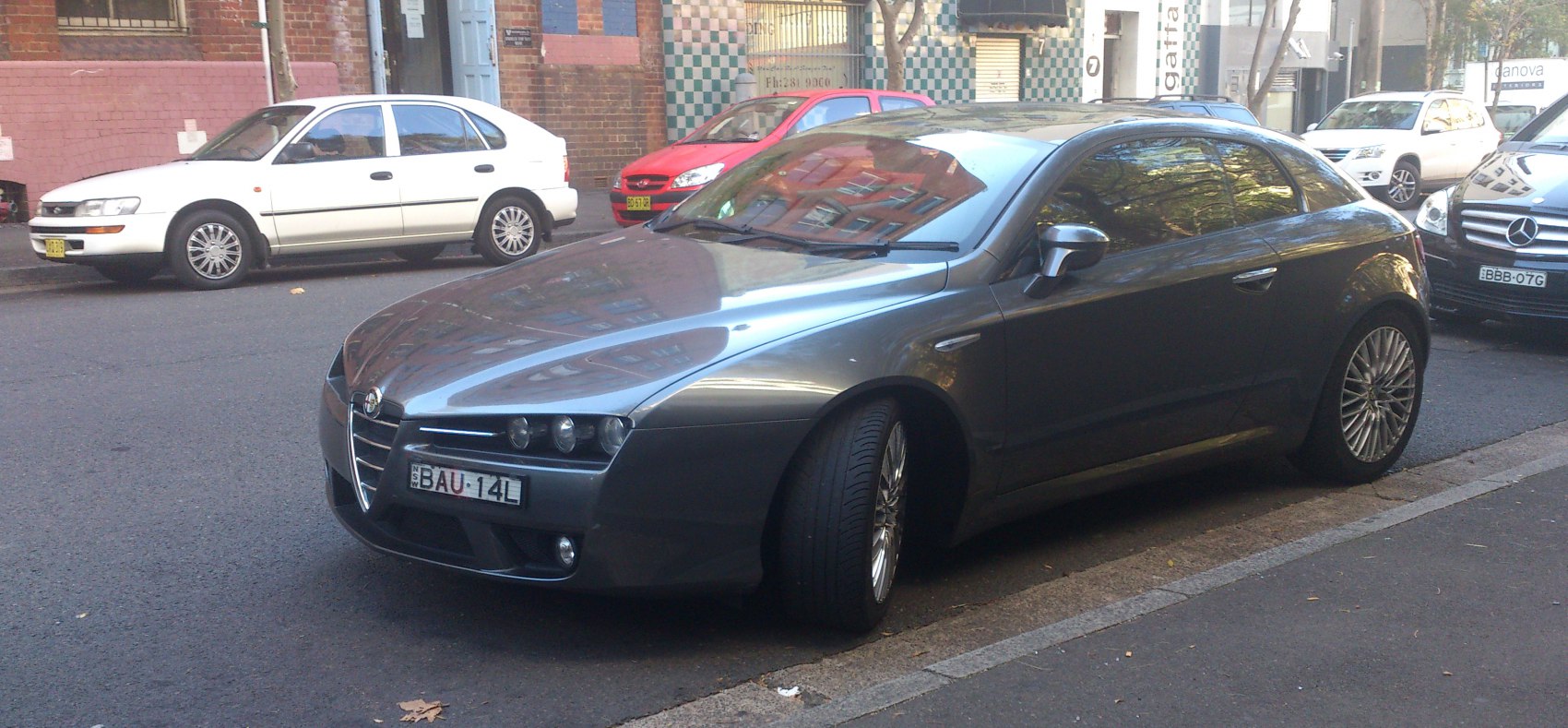 Silver coupe with distinctive headlights and alloy wheels from front angle