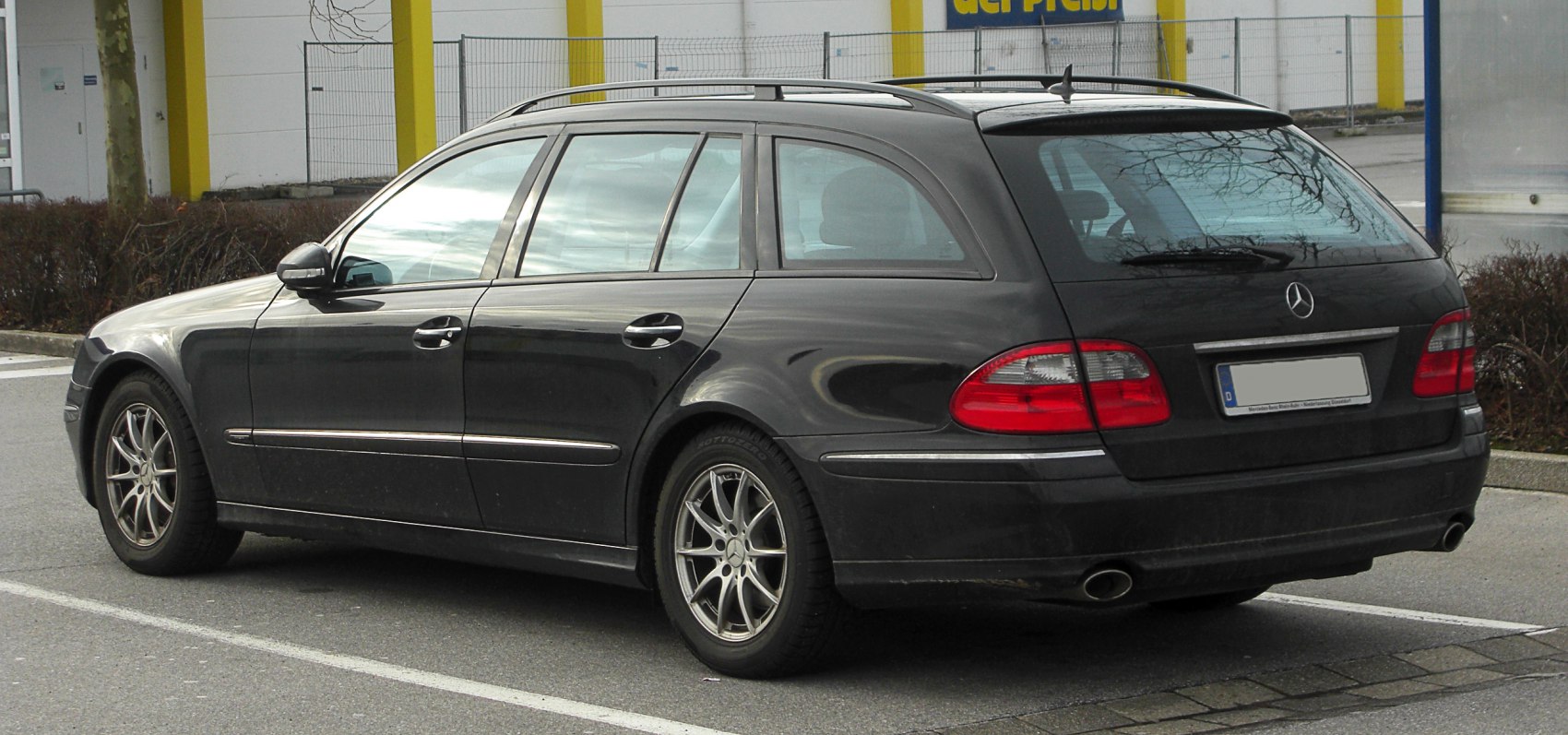 Side and rear view of station wagon with roof rails and alloy wheels