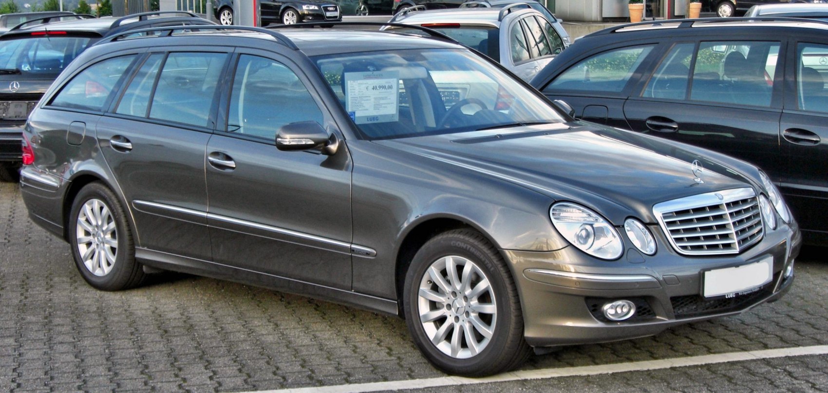 Front-side view of a station wagon with dual round headlights and chrome grille
