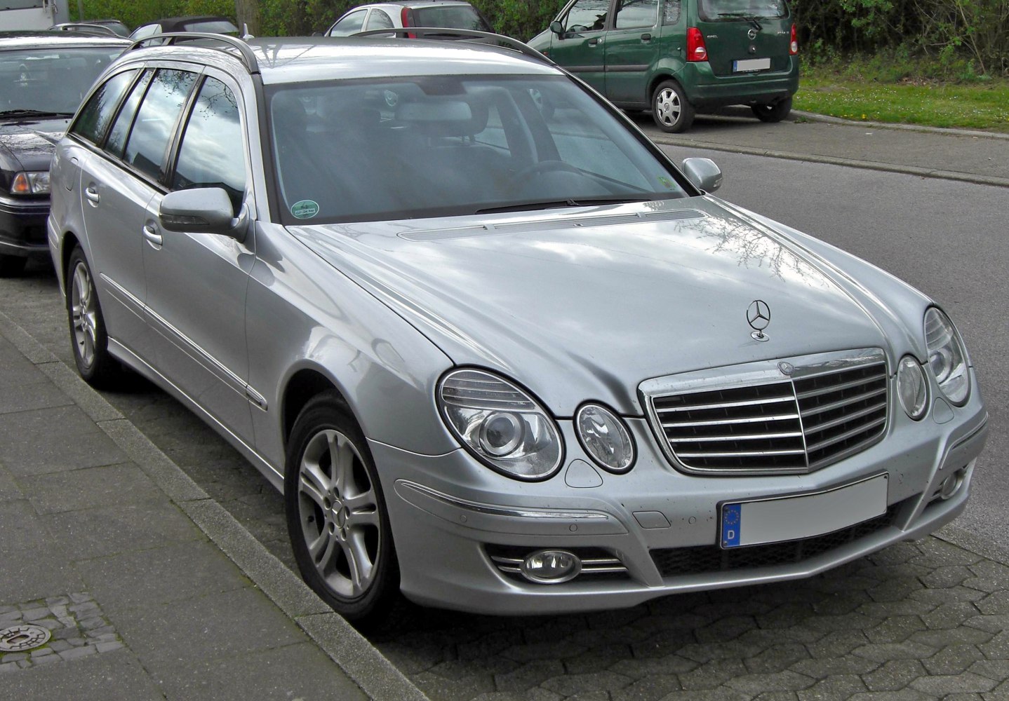Silver station wagon with distinctive oval headlights and chrome grille