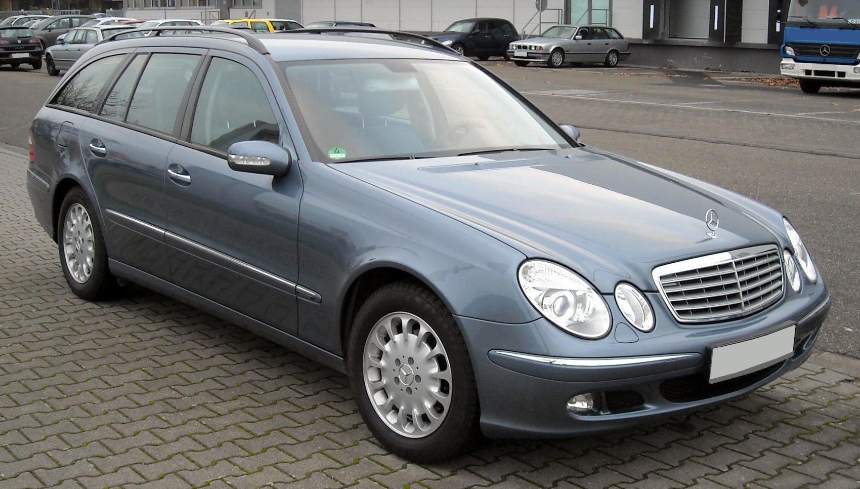 Front side view of estate car with distinctive headlights and grille