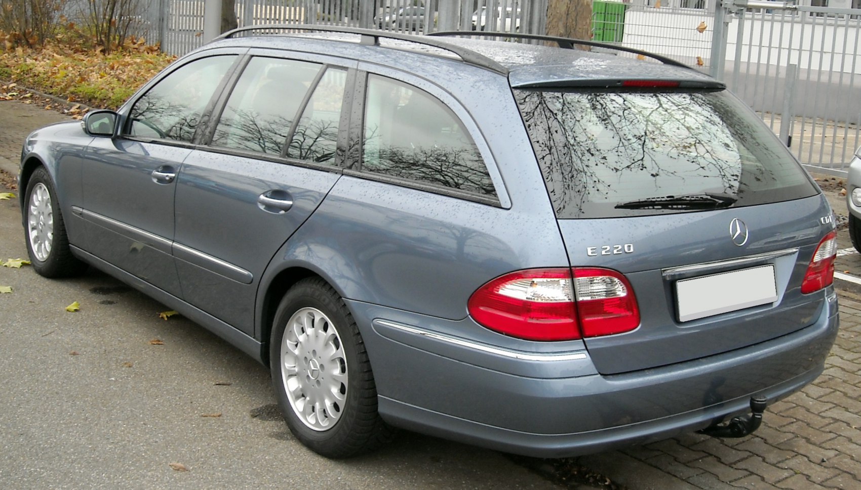 Rear side view of a classic estate car with roof rails and distinctive rear lights.
