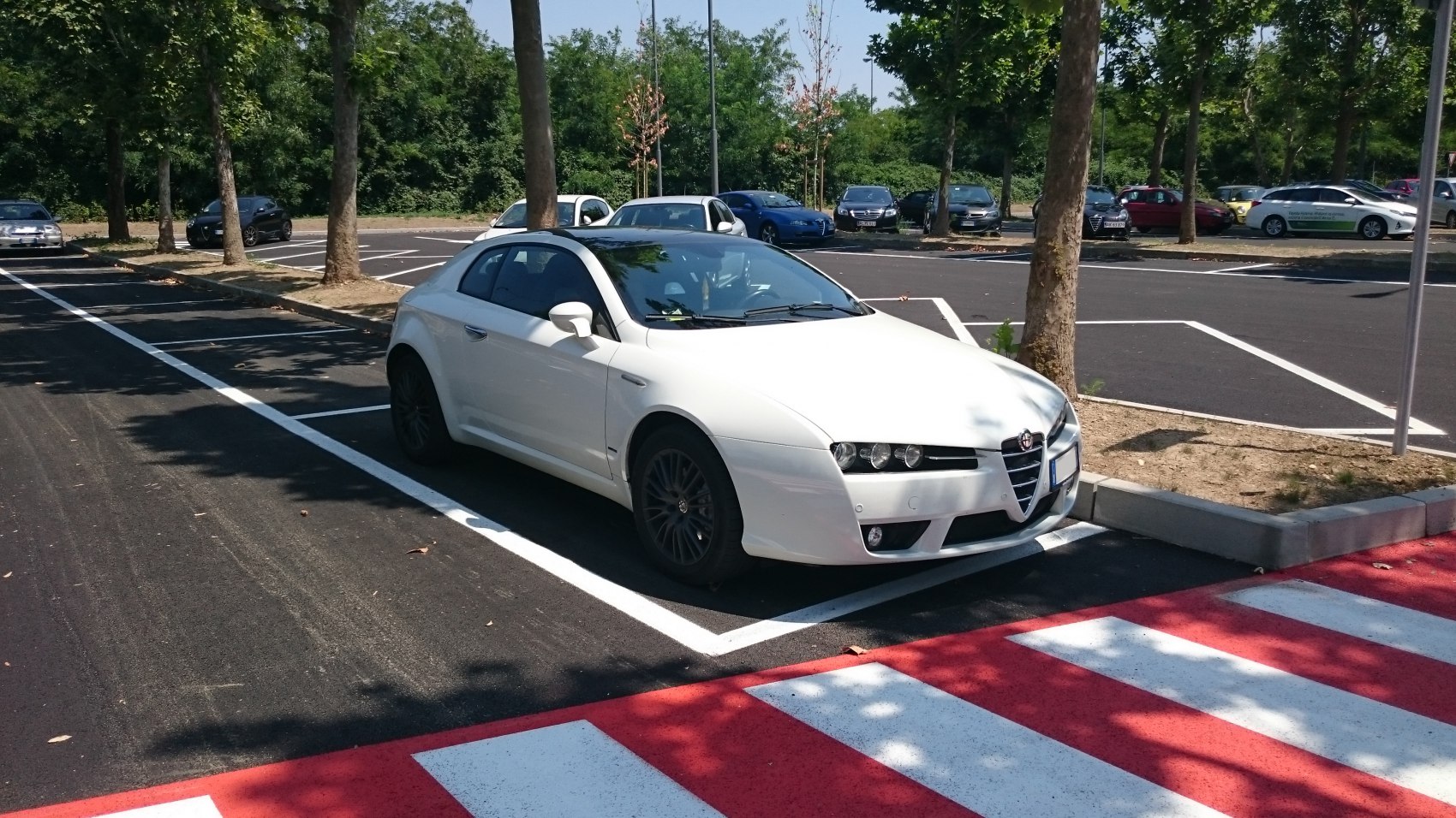 White coupe with distinctive front grille and sleek side profile