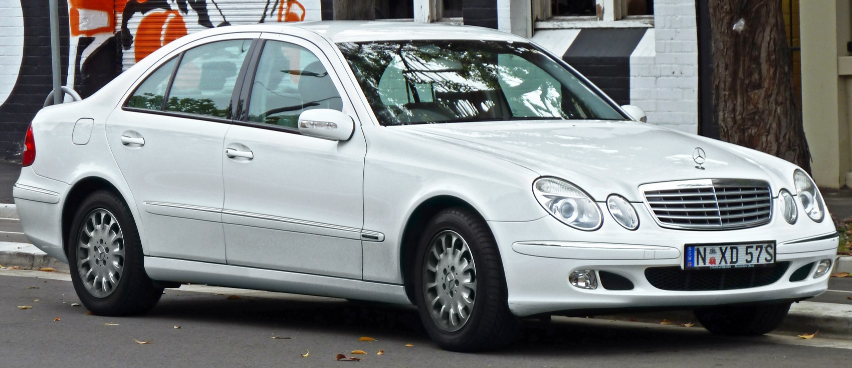 White sedan with quad round headlights and alloy wheels