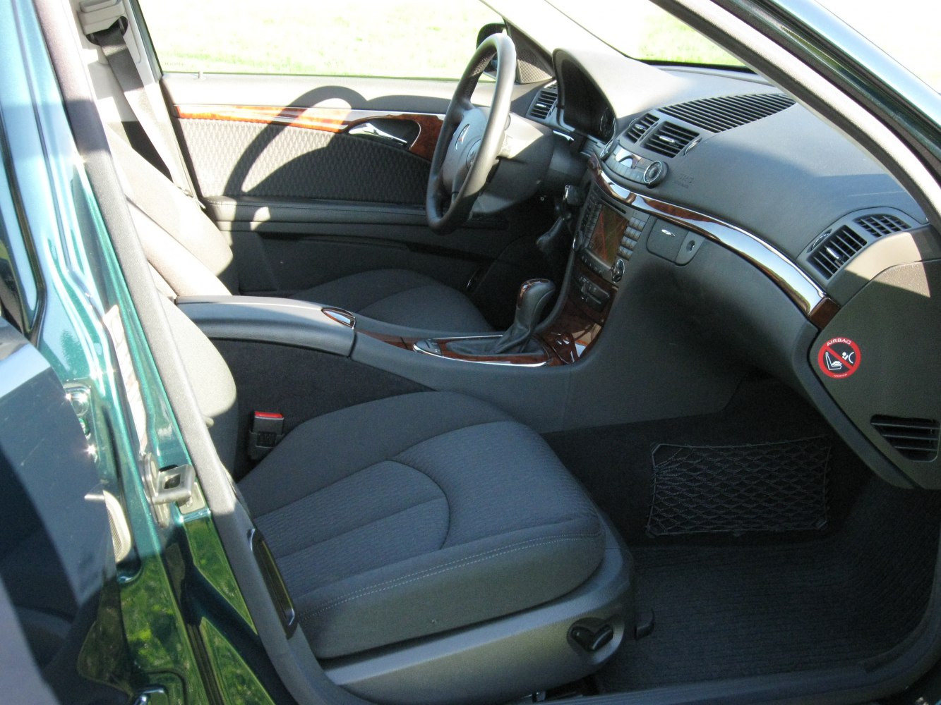 Interior with wood trim dashboard and fabric seats