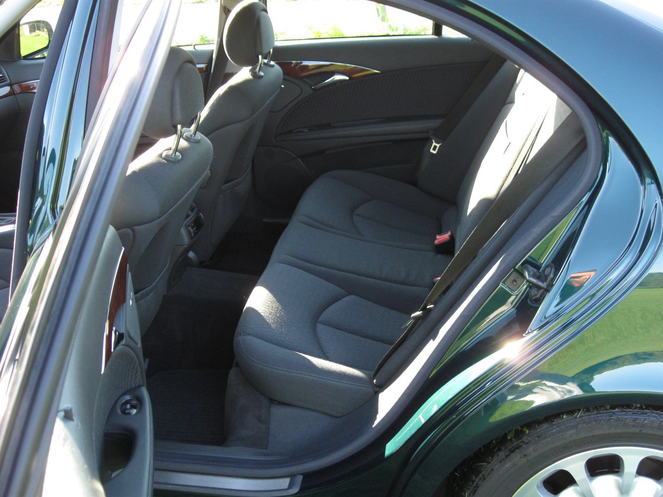 Rear fabric seats and spacious legroom inside the back door of a sedan