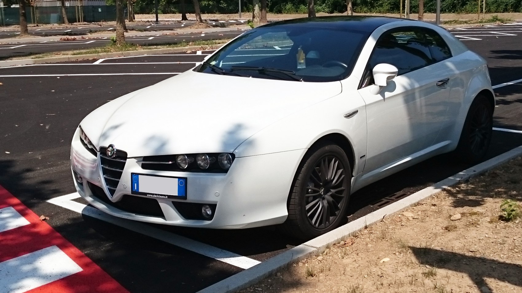 Front and side view with sleek headlights and black alloy wheels