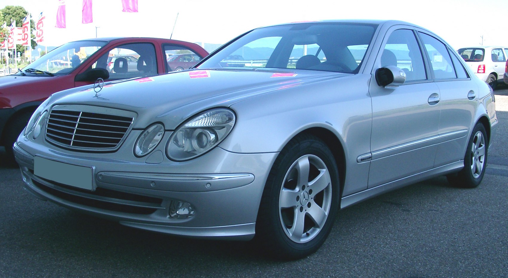 Silver sedan with distinctive headlights and grille, alloy wheels, viewed from front side.