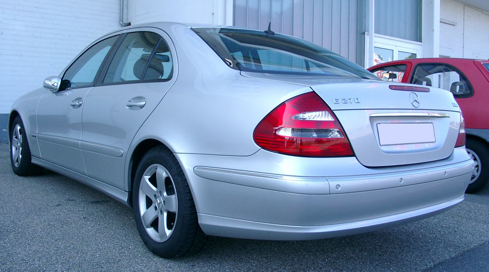 Rear-side view of silver sedan with distinctive taillights and alloy wheels