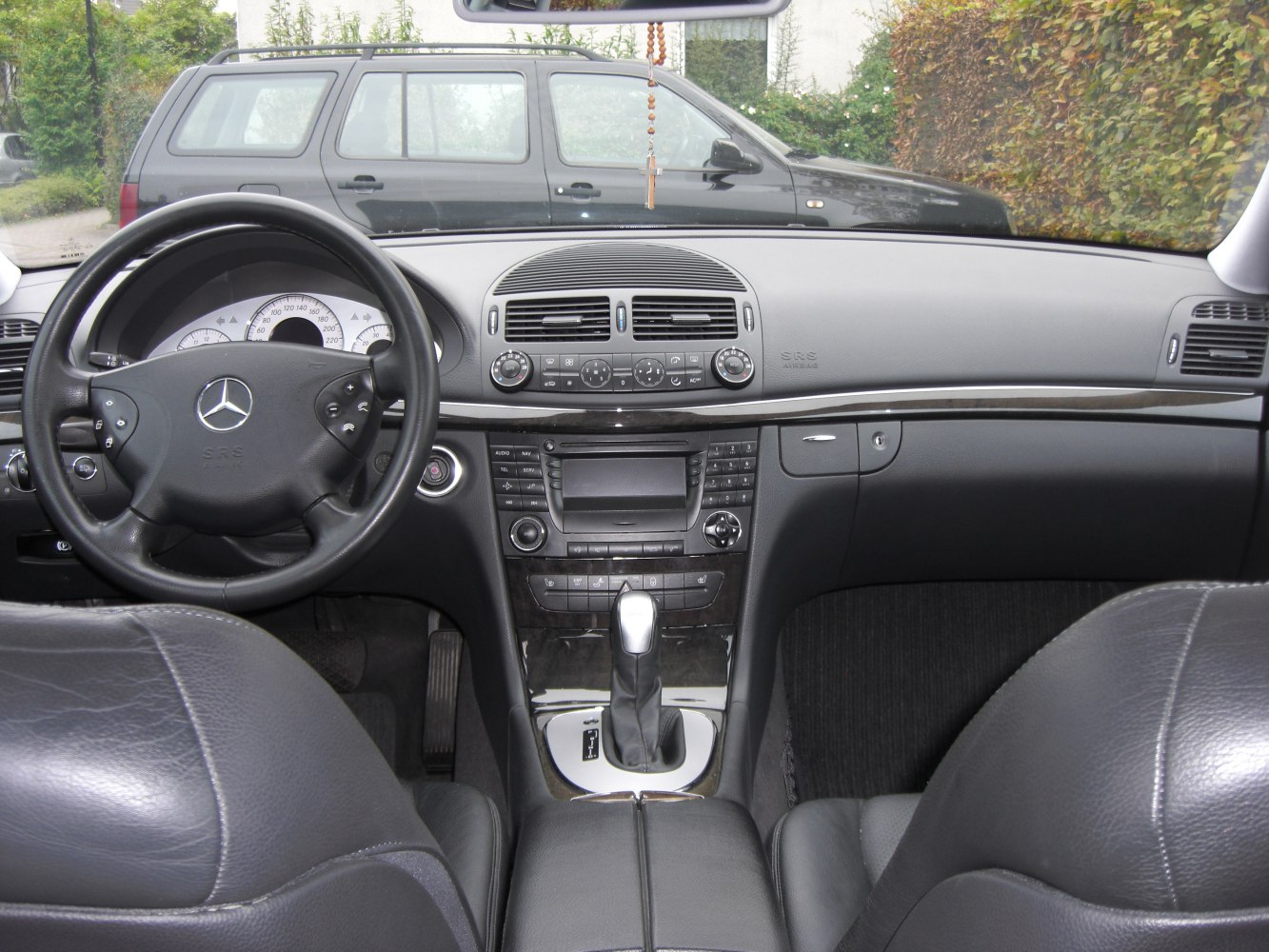 Luxury car interior with steering wheel and center console