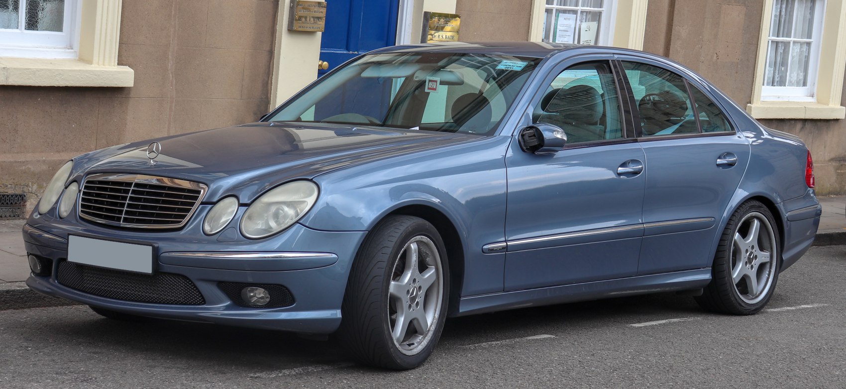 Luxury sedan with oval headlights and five-spoke alloy wheels