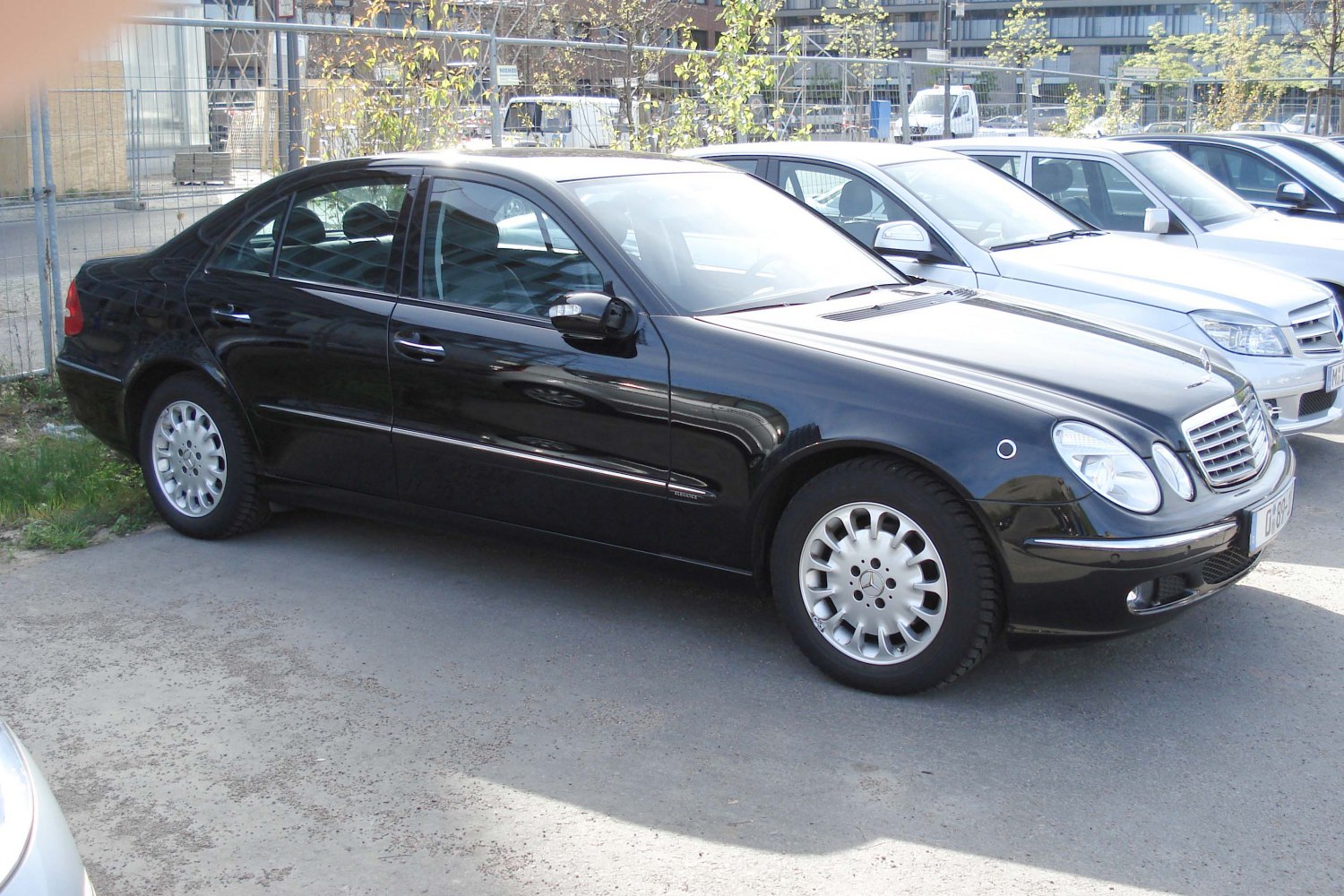 Black luxury sedan with sleek front side and distinctive wheels
