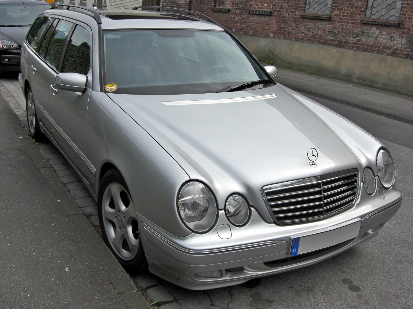 Silver station wagon with round headlights and chrome grille