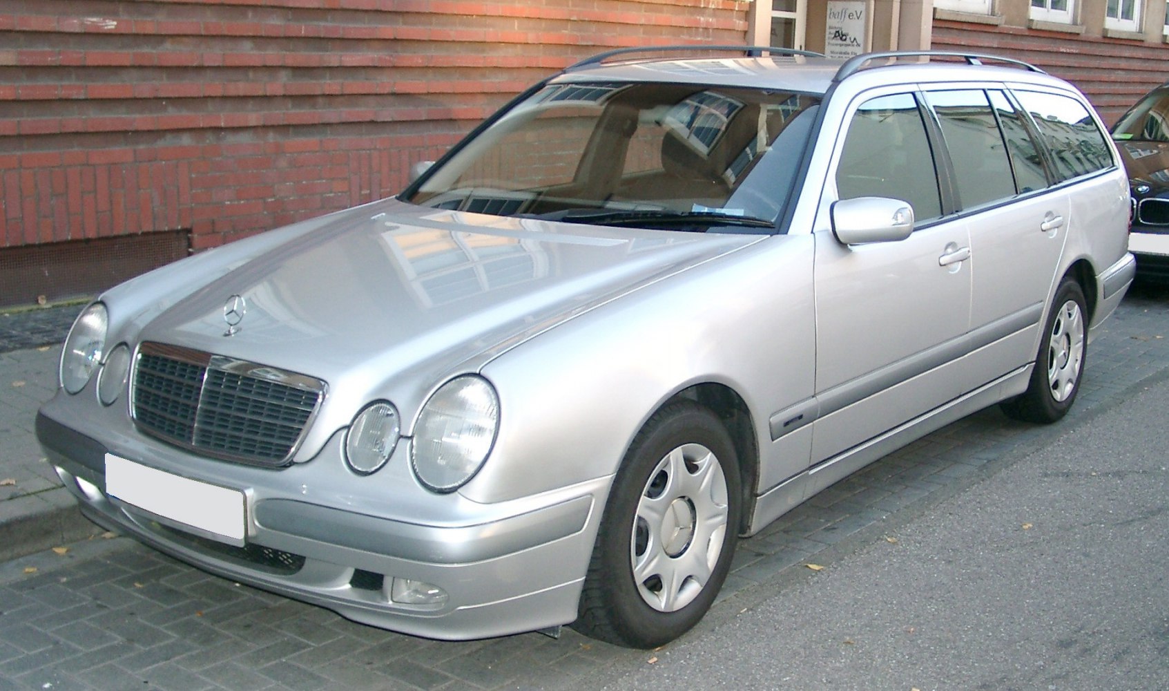 Silver station wagon with round headlights and roof rails