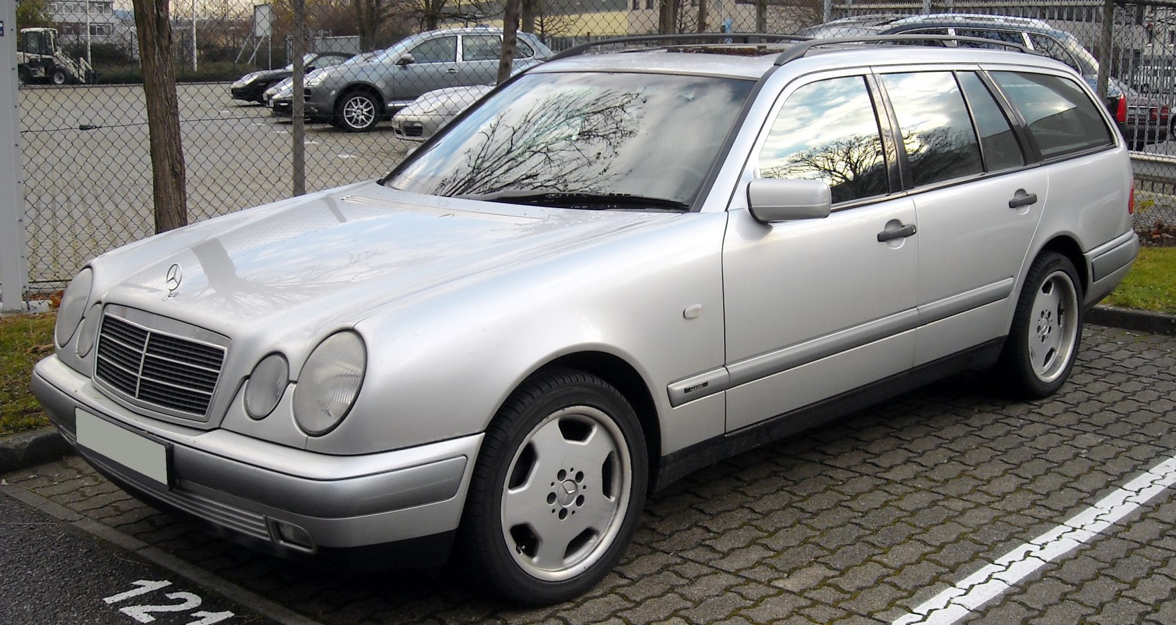 Silver station wagon with distinctive round headlights and roof rails