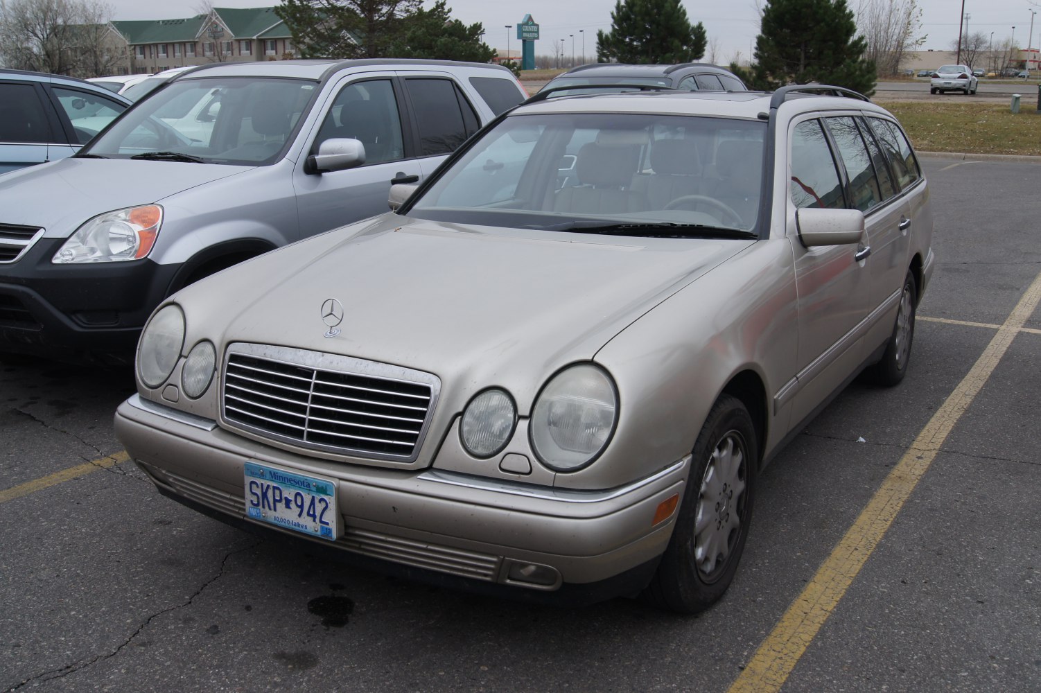 Front view of a classic station wagon with round headlights and chrome grille