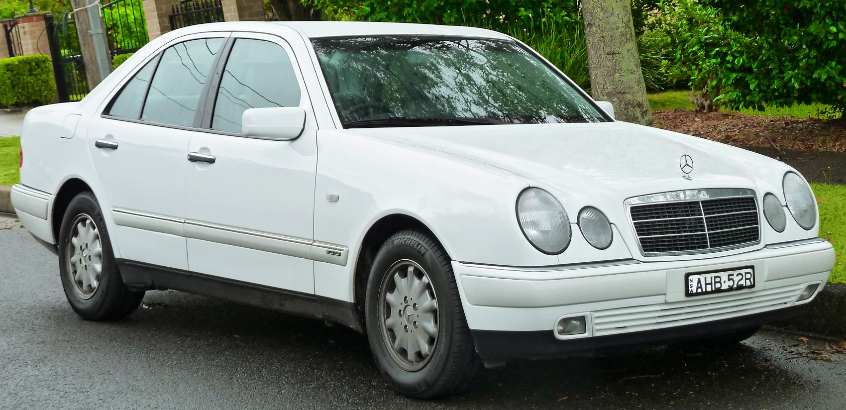 Four-door sedan with dual round headlights and chrome grille
