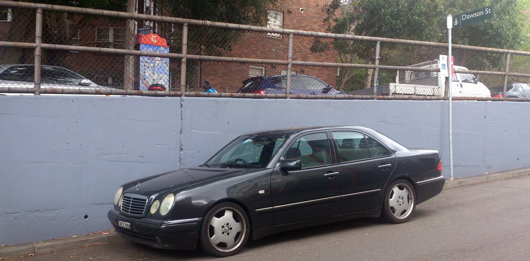 Black sedan with oval headlights and low stance wheels