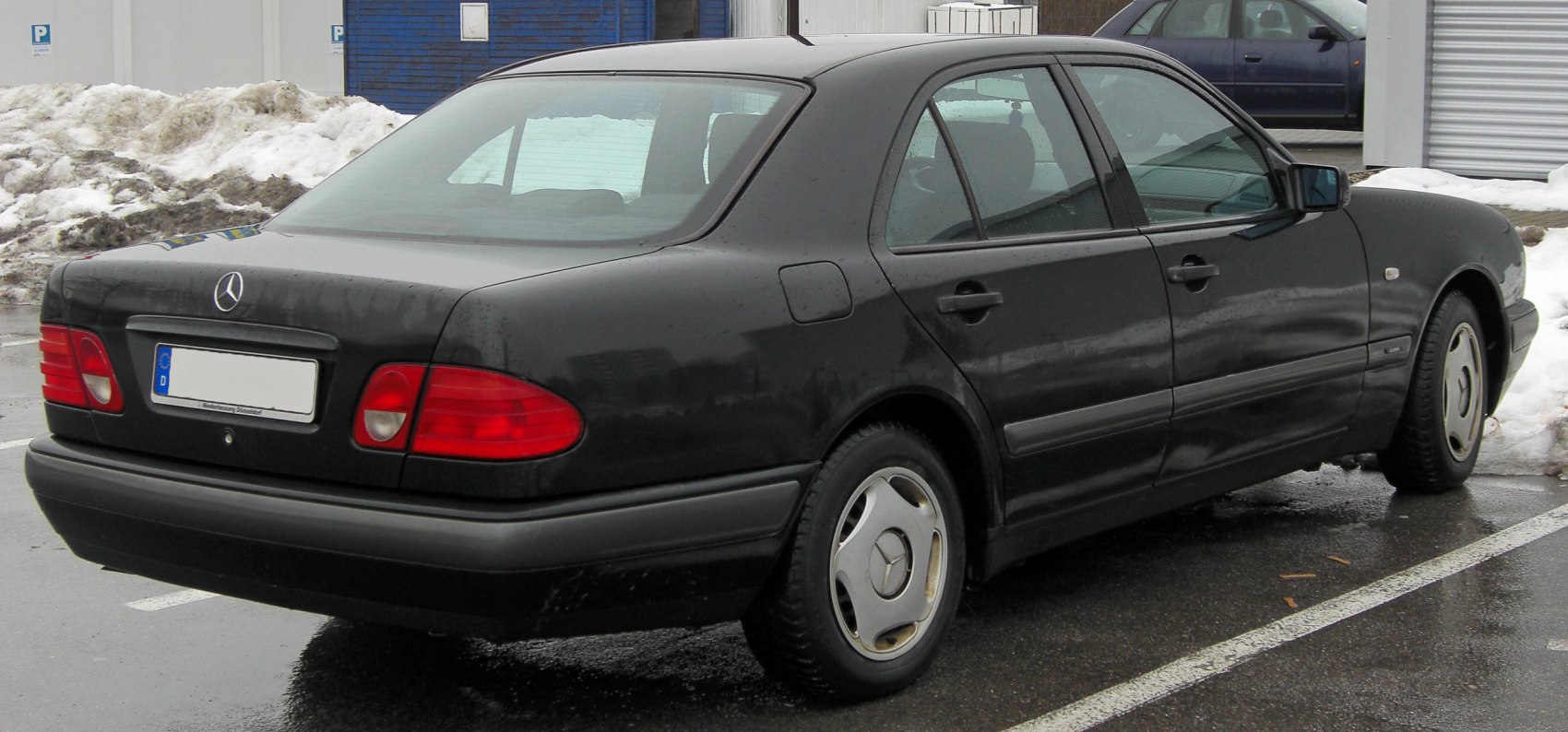 Four-door sedan with oval taillights and distinctive alloy wheels
