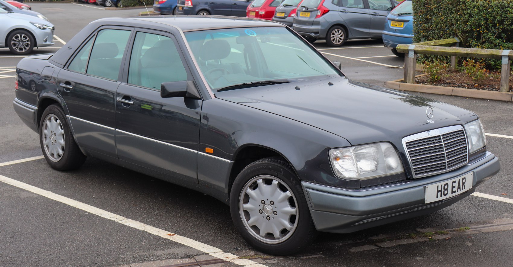 Classic sedan front-side view with distinctive grille and rectangular headlights