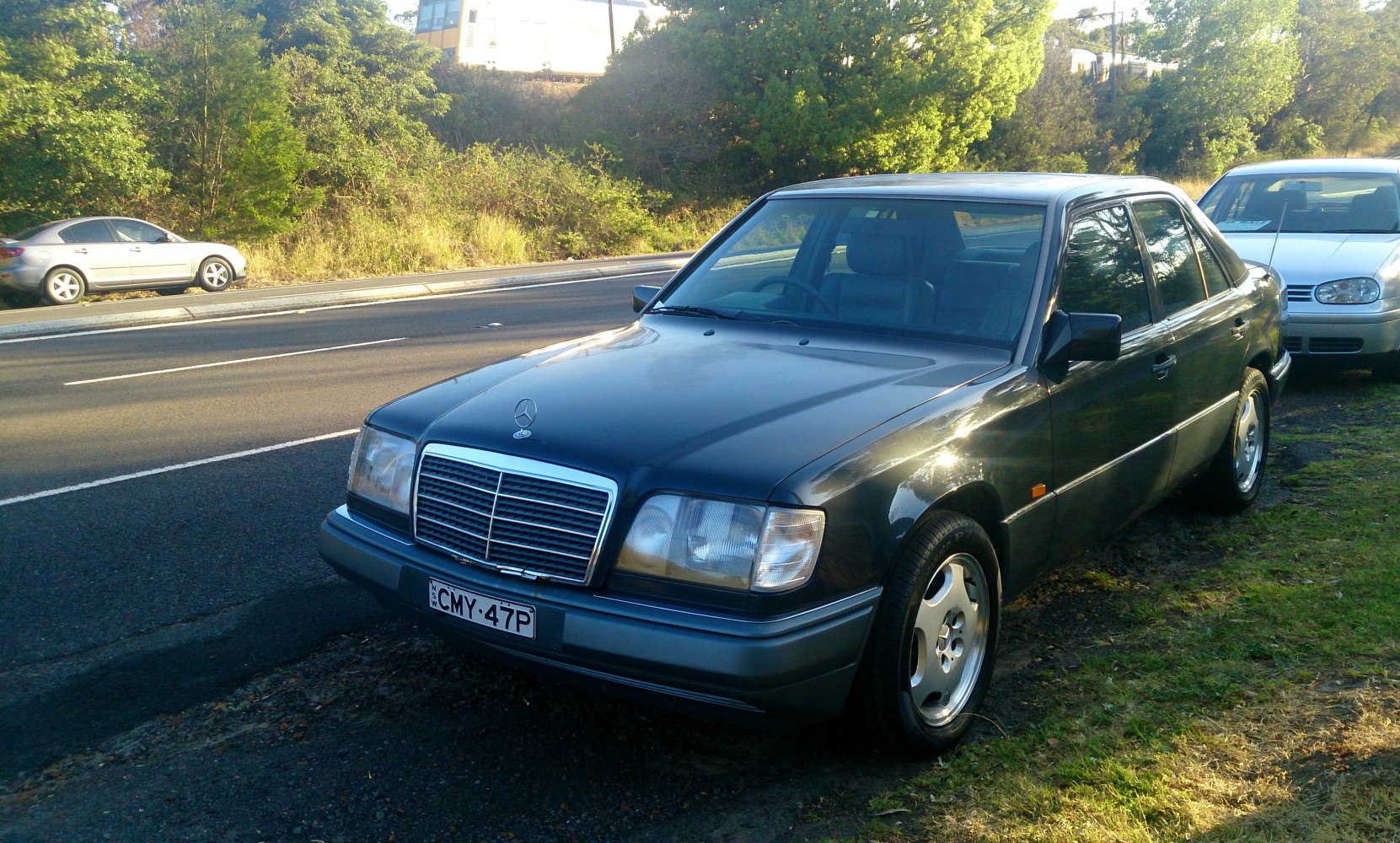 Classic sedan front-side view with distinctive grille and alloy wheels