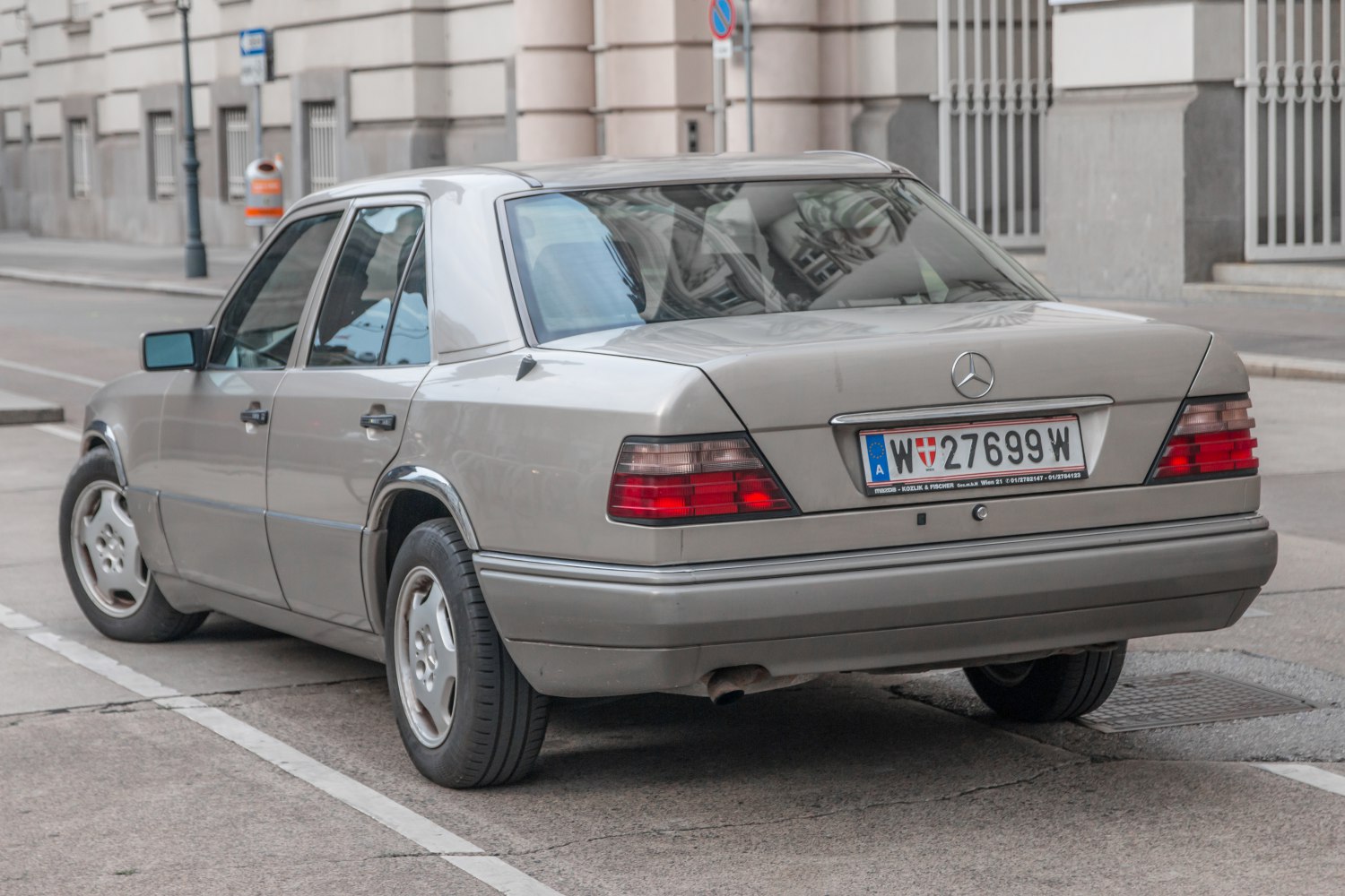 Rear view of classic silver sedan with distinct taillights and four doors