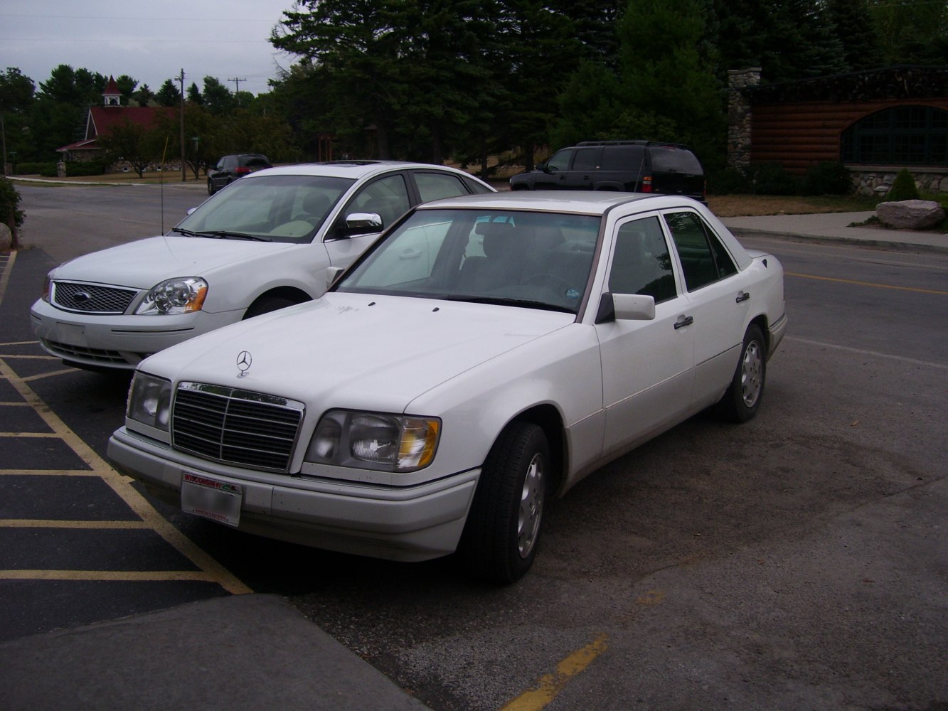 White vintage sedan with rectangular headlights and chrome grille