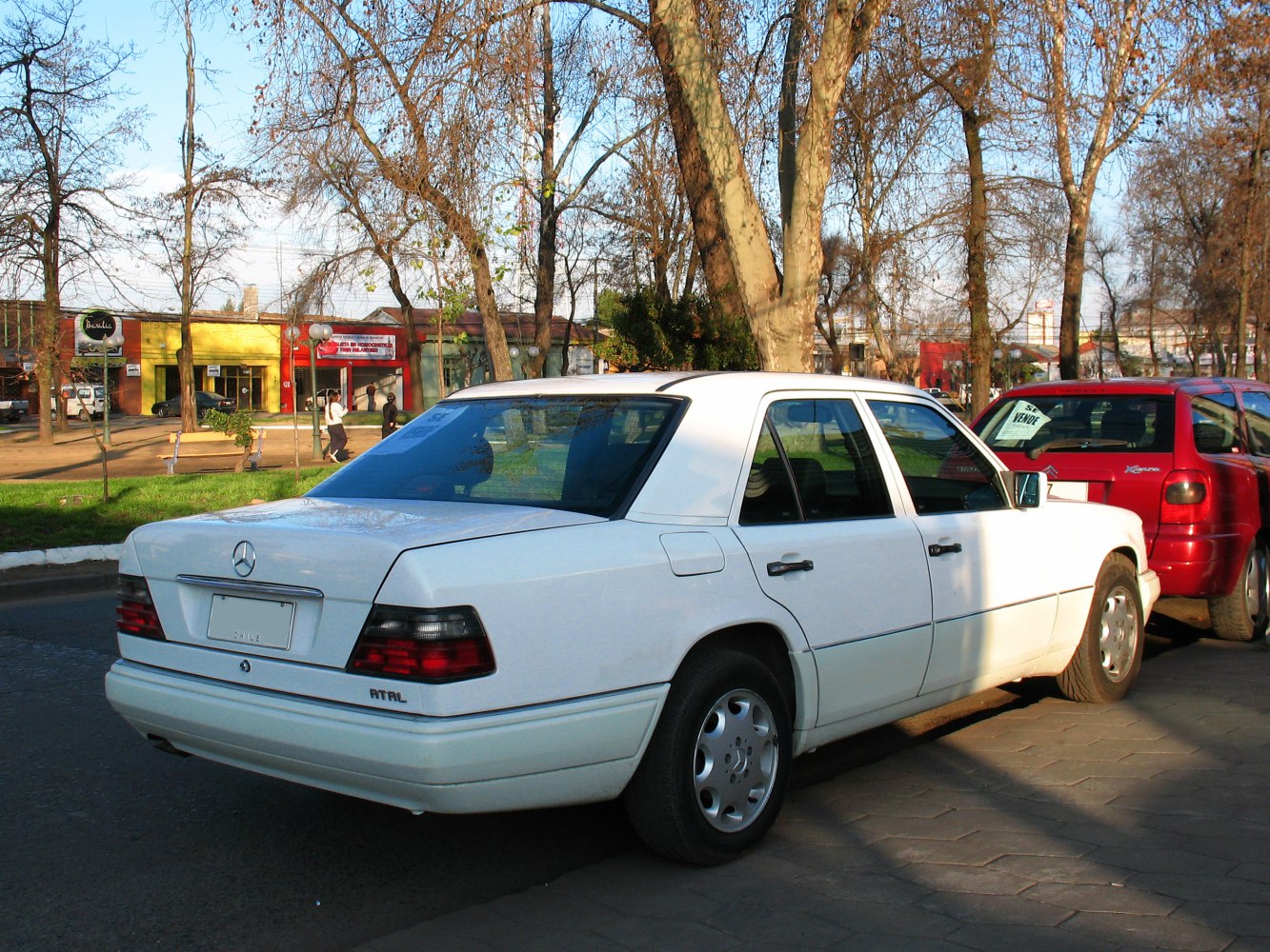 Rear view of a vintage sedan with distinctive taillights and alloy wheels