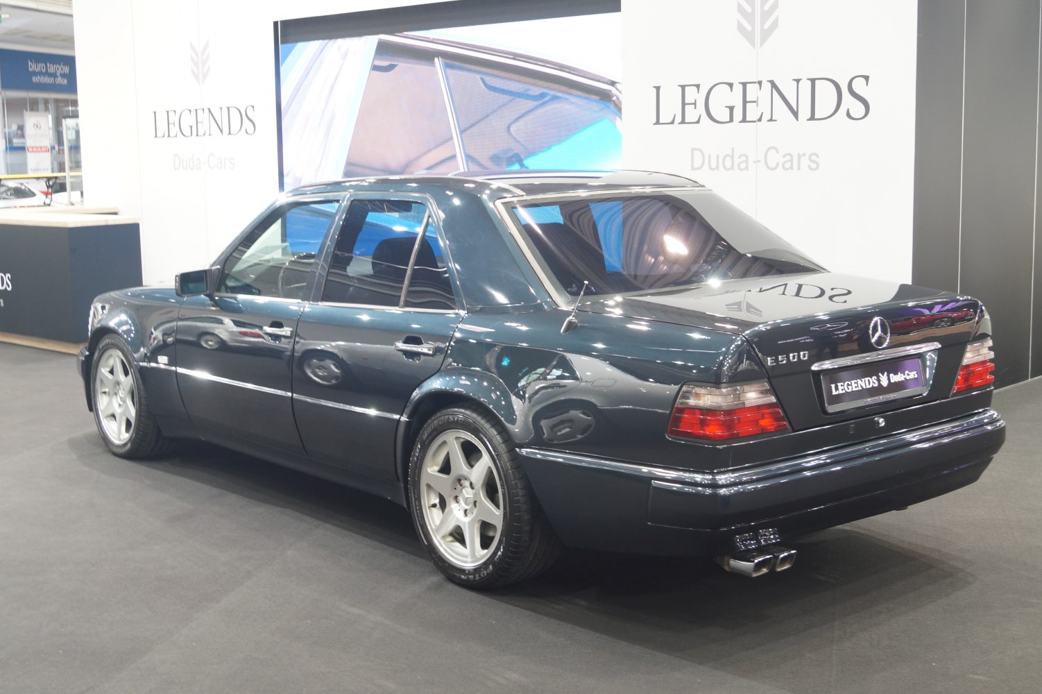 Rear and side view of a luxury sedan with alloy wheels and distinctive tail lights.