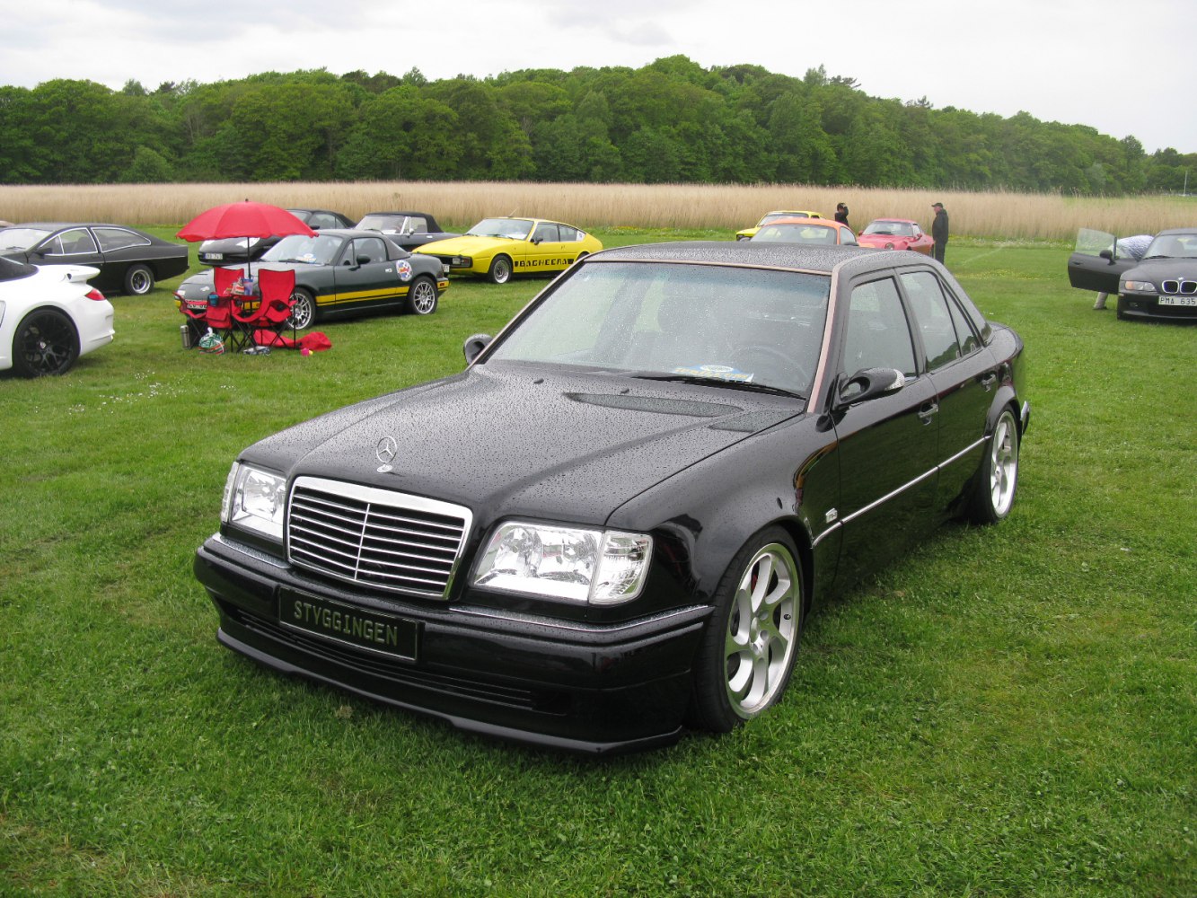 Customized black sedan with large alloy wheels and lowered stance