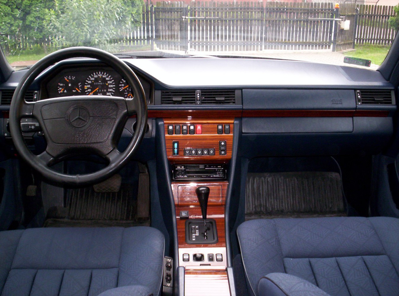 Classic vintage car interior with wood trim and automatic gear shift