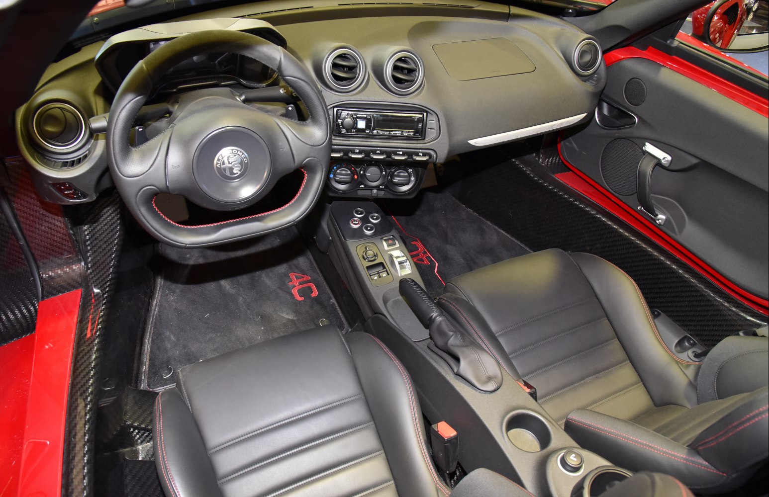 Steering wheel, dashboard, black leather seats with red stitching