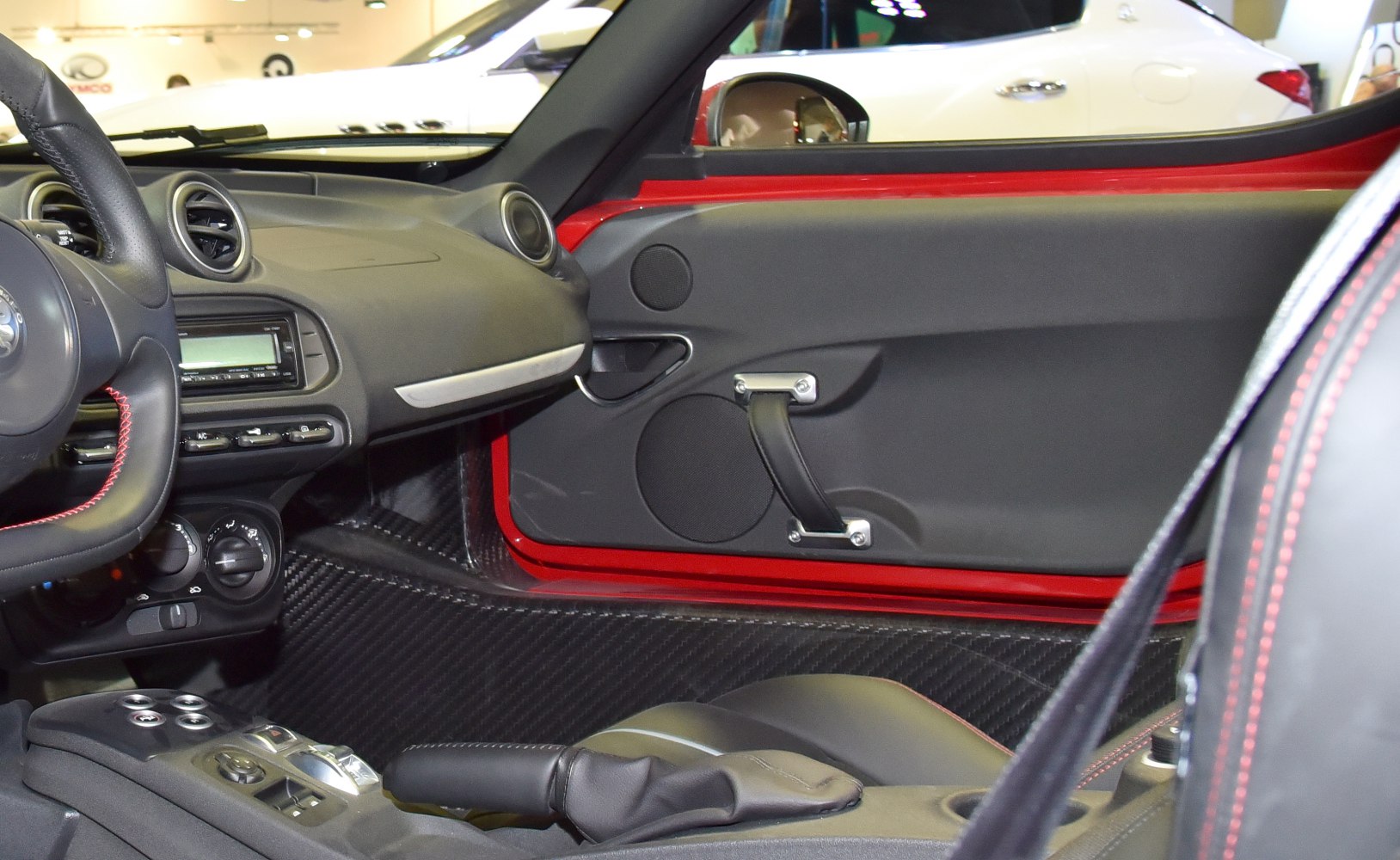 Carbon fiber trim and minimalist dashboard with red stitching details