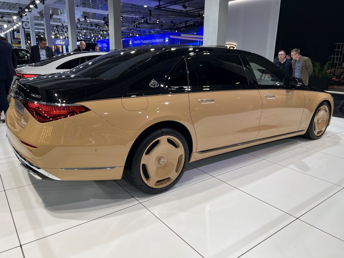 Two-tone tan and black luxury sedan with matching wheels