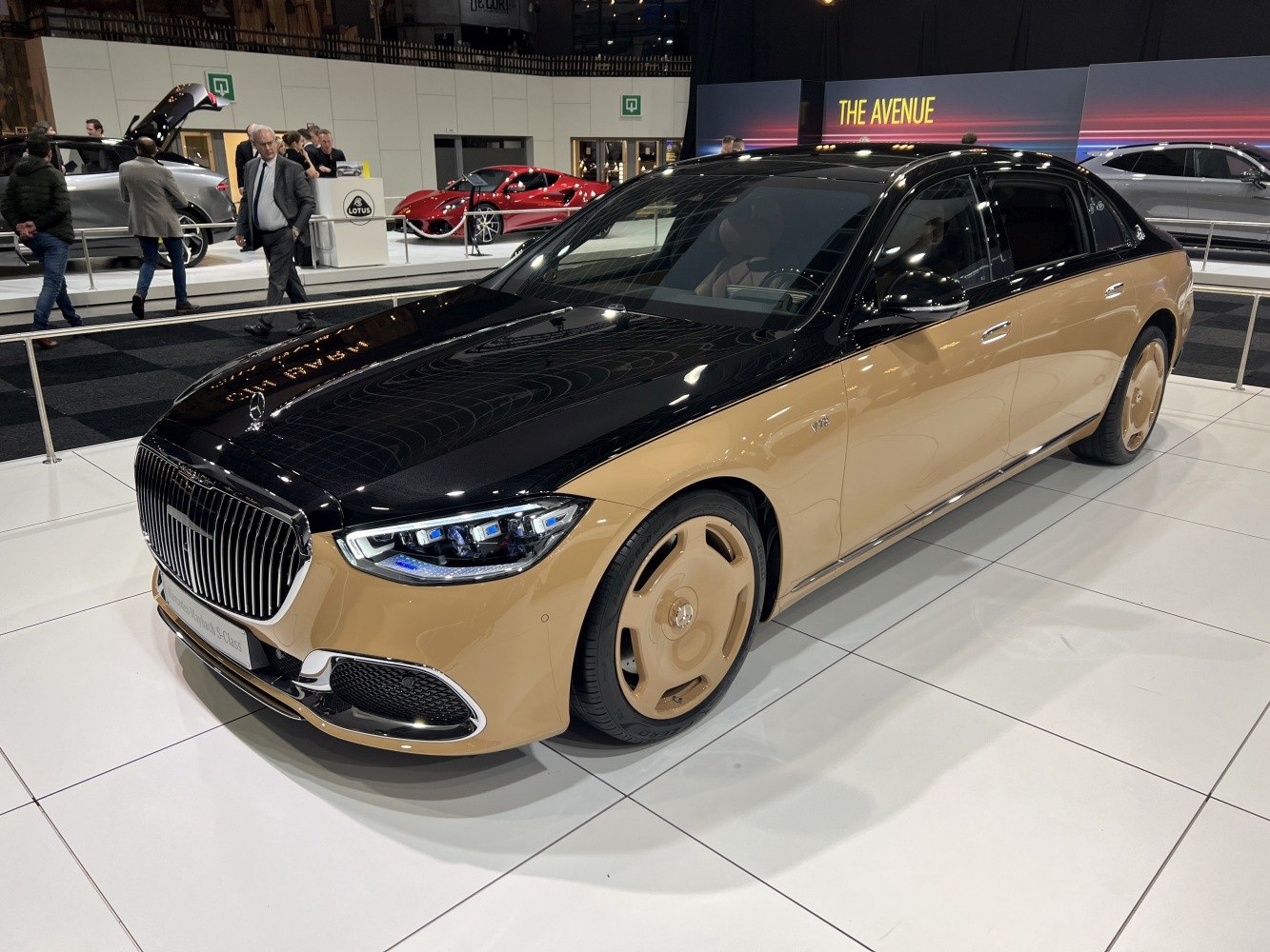 Two-tone luxury sedan with distinctive wheels and sleek front headlight design