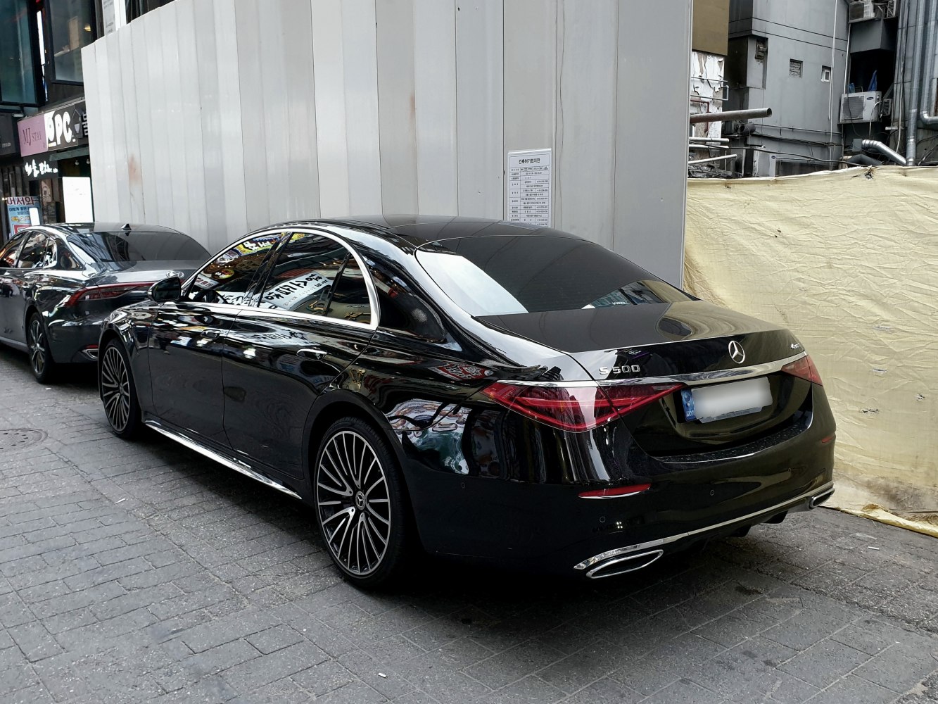 Rear side view of a luxury sedan with distinctive taillights and elegant design lines
