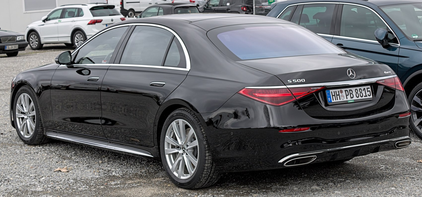Rear and side profile of black luxury sedan with sleeks curves and distinctive taillights