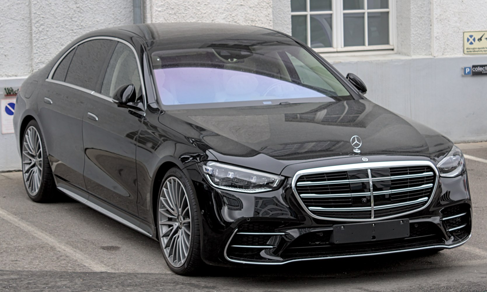 Front view luxury sedan with LED headlights and chrome grille