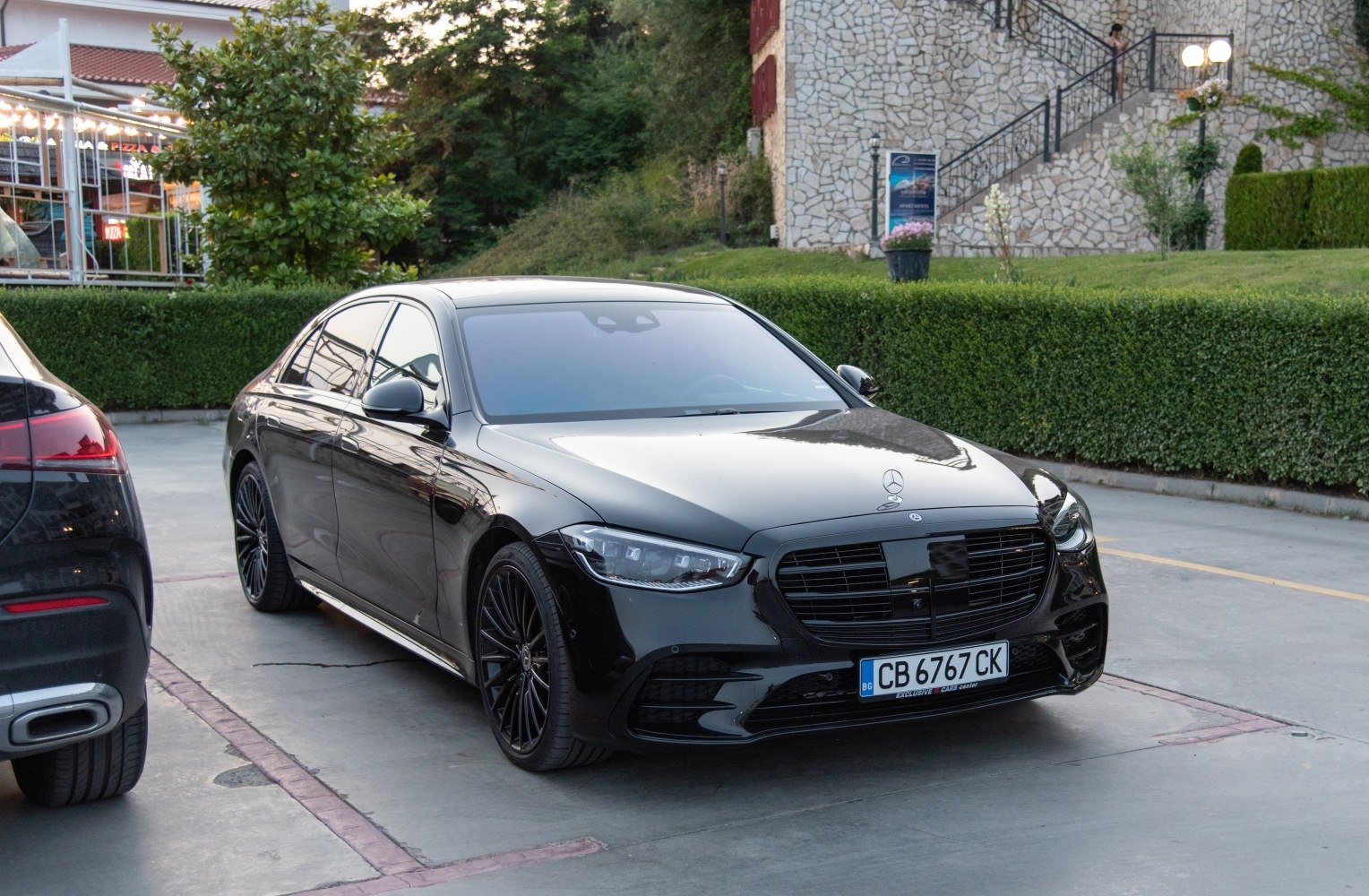 Black luxury sedan with LED headlights and blacked-out grille
