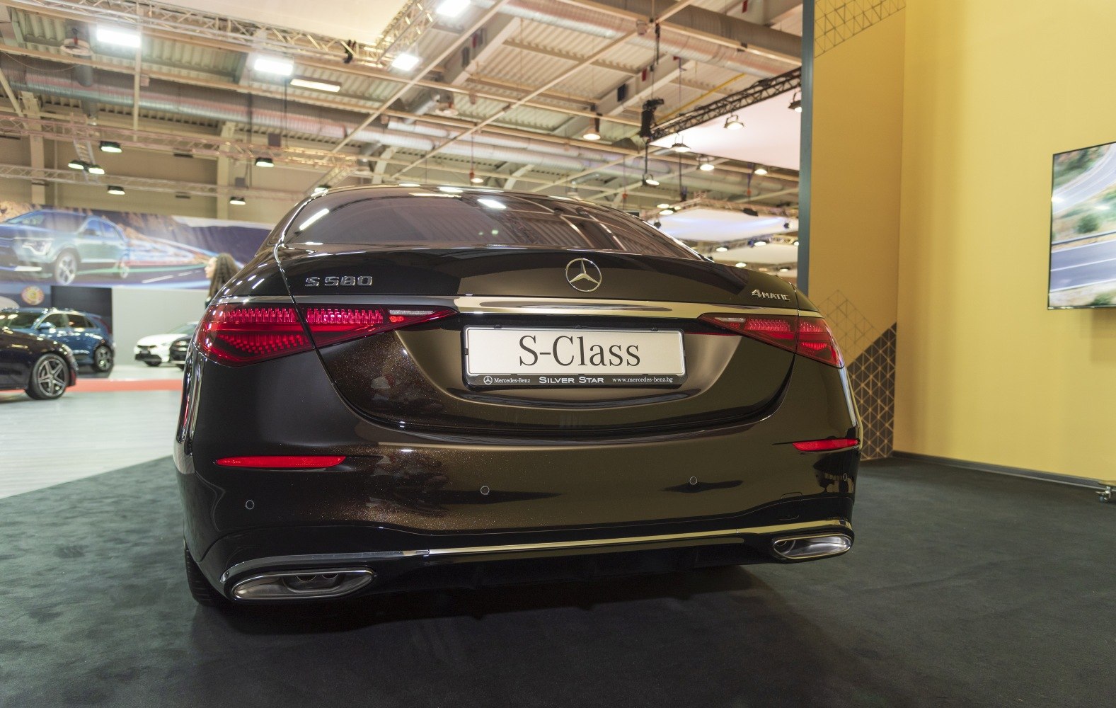 Rear view of luxury sedan with sleek taillights and dual exhausts