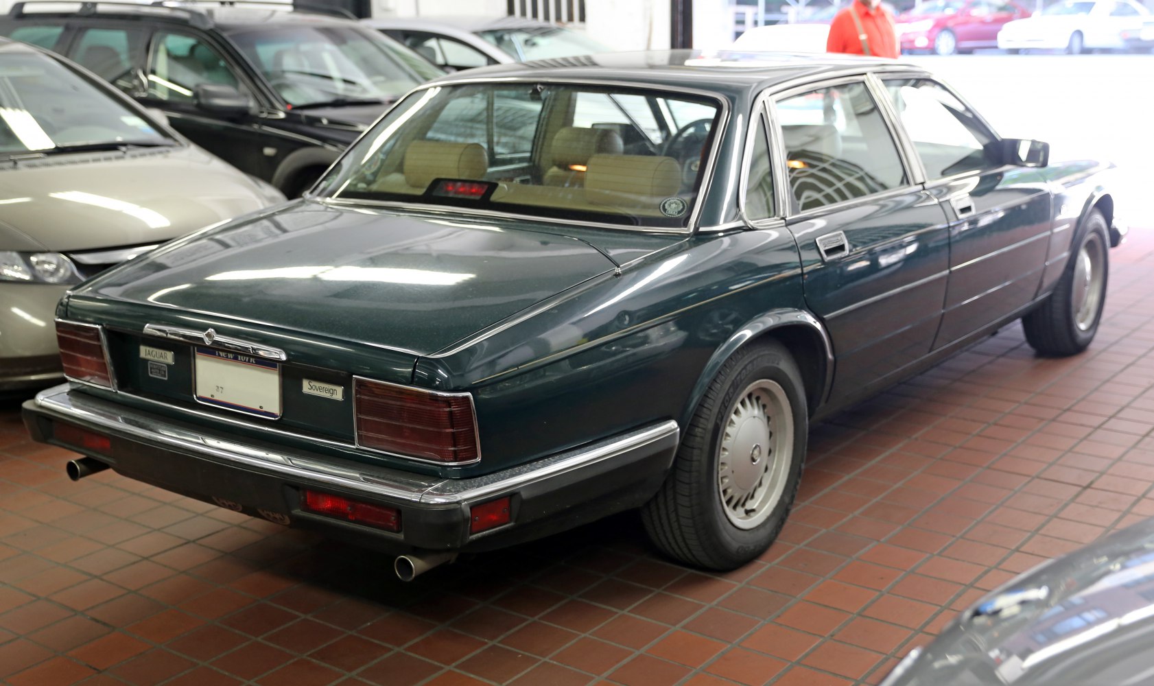 Rear and side profile of a classic luxury sedan with chrome bumper and alloy wheels