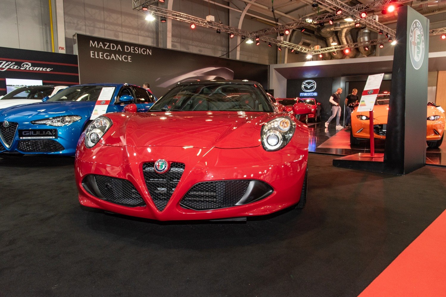 Front view of a red sports car with distinctive triangular grille and round headlights